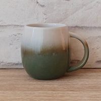 Green Ombre Stoneware Mug This gorgeous stoneware mug is part of our stunning Kitchen Collection and has been carefully crafted to give its distinctive finish. It boasts just enough elegance to elevate any room. Colour: Green   Dimensions: Height: 11.5cm Diameter: 8cm, Height: 4.52in Diameter: 3.14in   Material: Stoneware Capacity: 260ml, 9.15oz Dishwasher Safe: Yes Microwave Safe: Yes    If you are interested to see other items we stock from this range, please visit our online shop.