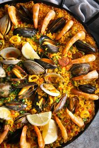 The most beloved of all Spanish dishes, Paella is an impressive combination of saffron-infused short-grain rice mixed with meat, seafood, and vegetables. Filled with traditional Spanish flavors, learn everything you need to know about making this delicious, crowd-pleasing Spanish paella recipe.