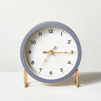 This Round Decorative Tabletop Clock in Gray/Brass from Hearth & Hand™ with Magnolia marries modern and retro style to create a stunning timepiece. Surrounded by a gray frame and resting on a brass base, this round analog clock features an off-white face that helps the numbers stand out for ease of reading. Place this analog clock on any tabletop with other decor in your home office, living room or any other area for a stylish look and convenient time-telling. Hearth & Hand™ with Magnolia: Gathe