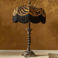 Handmade tiger-print lampshade with black fringe Tiger stripes + teasy tassels = perfection. This playful lampshade is handcrafted in the most luxurious velvet featuring bold stripes that have been colour-matched to emulate the coat of the Indian tiger. We've kept the braiding and fringe understated, because this pattern deserves to be the star of the show.The Tigress at a glance:Tiger-print velvetTonal braiding and black fringeLined in gold fabricWorks with table lamps, floor lamps and ceiling pendants not given Velvet