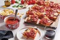 King Arthur's Detroit-Style Pizza Recipe | King Arthur Baking: A Detroit-style pizza with crispy, caramelized edges and a thick layer of sauce and cheese.