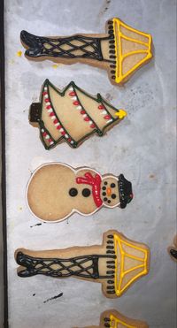 Christmas decorated sugar cookies with single lime designs. A christmas story leg lamp, simple snow man design, and a classic christmas tree.