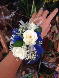 Indigo transparent ribbon with white roses, baby's breathe and silver details wrist PROM corsage by Mariam's Flowers.  #promcorsage #promribbon #promfloralarrangement