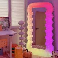 THIS ADORABLE RETRO MIRROR ILLUMINES YOUR INTERIOR WITH A STUNNING NEON GRADIENT    The  Duha  Mirror is a gorgeous art piece that is distinct from conventional mirrors Most mirrors are meant to be  looked in, but with the glowing wavy silhouette of the mirror, it is meant to be looked at. This stunning mirror functions as both a neon light and a functioning mirror. It features a wavy vacuum-formed acrylic frame around the exterior of the mirror that lights up in a multi-colored neon light. Avai