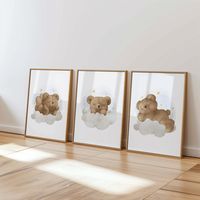 Set of 3 posters. Print to order. This Product is a PHYSICAL Paper Print.  This item is PRINTED and SHIPPED to you!  PICTURE FRAME NOT INCLUDED! "Dreamy Bear Clouds Nursery Set" Drift into the night with our Dreamy Bear Clouds set. Each poster features a sweet bear nestled in fluffy clouds under twinkling stars. This set is designed to create a soothing and comforting atmosphere, perfect for your little one's nursery. With soft hues and gentle expressions, these prints will help create a serene and peaceful sleep environment for your baby. We use professional Epson printers to print your posters.  Excellent color reproduction. The posters are printed on good quality photo paper 230 gsm. ⚬ MATERIAL ⚬ -Printed on 230gsm Fine Art Paper. -Used highly pigmented archival inks for quality and cla