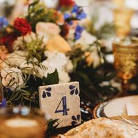 Blue and white table numbers, in the talavera aesthetic, each delicately adored with white flowers and whimsical leaves.  Enjoy these statement table numbers at your wedding, and to use afterwards in your home as a momento from your special day.   --->  (Images are mock ups of a new design that has not been made yet which is why you cannot see the stone pigment and why you can see layering.  One completed, all white/grey background will be stone color and the beige background will have some stome texture). Each table number is a 4"x4" stone tile made from either travertine or marble stone.  This listing is for 10 table numbers.  If you want more or less please message me for a custom order request.  On the back of each tile I can customize a personal logo with your names and the date of th