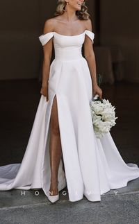 This gorgeous wedding dress features an off-shoulder neckline with a fitted bodice that is adorned with ruched detailing for added texture and sophistication. Crafted from high-quality satin, the skirt is cut in a classic A-line silhouette and finished off with a graceful train and side slit.