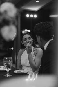 Documentary style photography of a wedding reception | Candle-lit reception, authentic documentary wedding photography, bride laughing