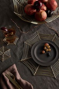 Weave a web of whimsical fun this Halloween season with a spider web-inspired trivet. | Spider Web Brass Trivet at Terrain