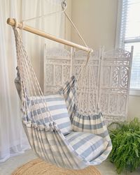 Transform any space into a luxurious oasis with this coastal-inspired white and blue hanging chair hammock. The bold stripes evoke a modern, seaside aesthetic, providing a breezy and relaxed atmosphere all year long. This design features beautiful and sustainable upcycled cotton denim fabric. It has a soft texture and breathability. This modern denim fabric hanging chair is handcrafted in El Salvador using a traditional artisanal process in a fair trade environment. This large adult-size hammock