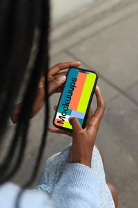 Check out this mockup featuring female hands holding a smartphone. The mockup is perfect for displaying your app or custom screen content. The phone is held naturally with a city sidewalk and blurred surroundings in the background, offering a realistic and relatable setting. Ideal for app developers or designers looking to showcase their work. #AppMockup #UIUX #PhoneMockup #DesignTools #MockupTemplates