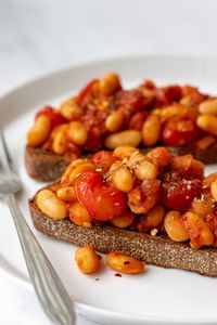 Phase 1, Phase 3, Cleanse: Baked Beans on Toast - Healthy, satisfying, and almost as easy as opening a can of Heinz. Swap xylitol or 20-30 drops stevia for maple syrup; use 1 cup canned cannellini beans and 2 slices sprouted grain bread to serve 2. (Instead of pasta, you can just use extra tomato puree.) For non-healthy fat days, saute in broth instead of oil.