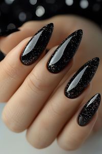 Add a touch of dark elegance and glamour with these black glitter stiletto acrylic nails. Perfect for those who love a bold and sophisticated style, these nails feature a sleek stiletto shape and sparkling black glitter, making them ideal for special occasions or a night out. #AcrylicNails #StilettoNails #BlackNails #GlitterNails #NailArt #NailDesign #Manicure #GlamNails #NailInspiration