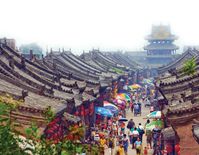 AN ANCIENT CITY FROZEN IN TIME  Pingyao is an archaeological site with a difference: 30,000 people still live in it. Once the banking capital of China, it has been continuously occupied for more than 2,700 years, and today provides an astonishing picture of life in Imperial China. But, asks Tom St John Gray, are tourist dollars turning the city into a theme park of the past?