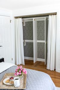 Closet transformed from a double door closet with center partition to one wide opening closed off with drapes - love!