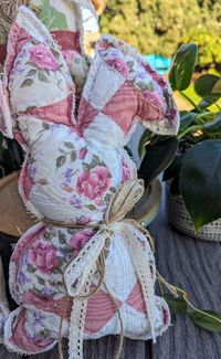 Embrace the essence of Easter with our handcrafted Vintage Repurposed Quilted Bunny decoration, carefully crafted from upcycled old quilts that exude a delightful air of nostalgia and charm. Each Quilted Bunny is a one-of-a-kind creation, featuring gorgeous vintage colors and a touch of sentimental value that elevates your Easter decor to a new level. Every bunny has a little special charm with some lace, maybe a button and a bit of jute.  Tall bunnies are 14" tall by 7" wide and the squatting bunnies are 9" tall by 11" wide.  Each bunny is carefully stuffed and backed by a natural canvas.  Edges are left raw for a farmhouse look!  To see the Quilted Easter Eggs in last photo, click this link: https://www.etsy.com/listing/1686094811/vintage-repurposed-quilted-easter-eggs?click_key=2f288f8e