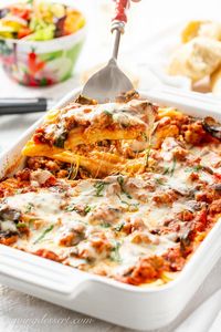 Enjoy this hearty and delicious Italian classic - Stuffed Manicotti with Sausage and Spinach. With make-ahead directions for your next dinner party! #stuffedmanicotti #manicotti #stuffedshells #Italiandish #pasta #Sundaysupper #Italiansausage #manicottirecipe #bakedmanicotti #dinner