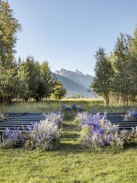 This Jackson Hole mountain view wedding featured several shades of blue wildflower arrangements surrounding guests that blended seamlessly with the natural beauty. Laurie Arons planned this outdoor ceremony and tent reception at Snake River Ranch with the iconic Teton Range as the backdrop. The reception featured colorful wildflower centerpieces that ran the length of the tables with escort cards tucked among purple and green wildflowers.