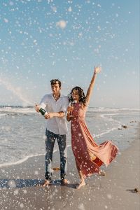 Engagement session at Jacksonville Beach Florida | sweetest champagne spray by Madison Shea Photography based in North Florida