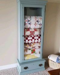 Old gun cabinet refinished into quilt storage!