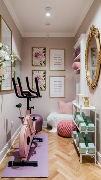 Transform your home gym with sophistication and soft pastels! 🌸 Featuring a blush pink exercise bike, lavender yoga mat, and mint green dumbbells on a white shelf. Framed floral artwork and motivational quotes in gold frames add elegance. A cozy corner with a white fur rug and pink ottoman is perfect for post-workout meditation. 🌟 #PastelGym #ElegantFitness