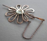 This shawl pin or scarf pin featuring hand forged daisy flower design, made with 14 gauge solid copper wire, accented with coin shape fresh water pearl (12mm in diameter) that finished up with chained pin stick for more character and extra security. It was tumbled, oxidized and hand polished for