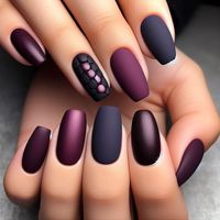 All nails are painted in a deep eggplant-purple color, with a mix of matte and glossy finishes. Some nails are matte, while others are glossy, creating a subtle yet striking contrast. This design plays with texture while keeping the focus on the bold, fall-appropriate color.