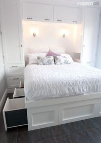 Built-in Wardrobes and Platform Storage Bed, ship lap and lights on wall, openings on either side for books or alarm clocks.