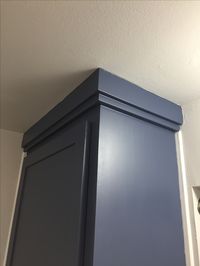 The cabinets were lacking style , just square boxes so we overlapped wood trim at the top for a shaker version of crown mold to go with our new doors!