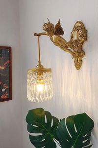 This exquisite wall lamp enhances the charm of any room. Handcrafted by skilled artisans, the fixture features a putti angel for a touch of elegance. The intricate detailing is remarkably lifelike, showcasing the masterful craftsmanship of this piece. Additionally, its resilience and functionality make it a durable and practical lighting element. Imparting a warm, luxurious look to your home, it seamlessly complements a variety of color schemes. Note: If you need to buy two, please buy the size