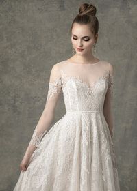 The Lacie wedding dress has a lace cutout design throughout an A-line gown, with illusion long sleeves, sweetheart lining, buttons down center back, and is fully lined with lace. #wedding #weddingdress #longsleeveweddingdress #longsleevedweddingdress #weddingideas #weddingdressstyles #laceweddingdress #lacedress #weddingdresses #bohobride #bohoweddingdress