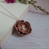 Handmade copper and sterling silver accented rose necklace. Beautiful handmade copper and silver rose like flower design necklace. A perfect gift for ladies, this feminine necklace is a lovely everyday item of jewellery. Copper is the gift for 7th wedding anniversary. Handcrafted in my Shropshire studio, I produce a limited number of these pretty necklaces as each one is handcut, textured and shaped by me. The flower measures approx 2cm x 2cm and hangs from a delicate 18 inch sterling silver tra