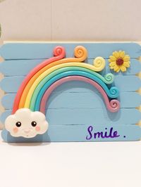 Handmade with jumbo lolly/popsicle sticks decorated with Handmade rainbow and flower made from crayola model magic airdry clay coated with a pva and water mixture to strengthen.