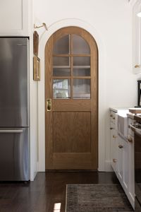 Arched Pocket Door - Hamilton Park Home arched pocket door, pocket door, arched door, diy arched pocket door, diy door, diy arched door, arched doorway, wooden pocket door, wooden arched door, white oak door, door with windows, interior door with windows, interior windows, how to arch a pocket door, how to arch a doorway, diy ached doorway, pantry door, arched pantry door, kitchen, white kitchen, pantry, laundry room, mudroom, laundry room door, arched windows, simpson door company, custom door