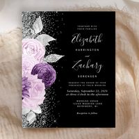 The left-hand edge of this elegant modern wedding invitation features a floral bouquet in shades of purple and lavender, trimmed with silver faux foil and faux glitter foliage and sprinkled with silver faux glitter. The customizable text combines pale silver gray handwriting script, copperplate and italic fonts on a black background. The reverse side features a matching floral design.