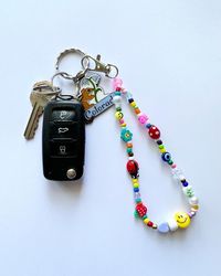 You will receive 1 random mix keychain wristlet/bag charm beaded by me with luuvvvv and will look similar to those pictured <3  Can put a custom name/word in block letters or no personalization at all! ️🌼 Length is measured including metal clasp, will be around 13-14" in full size (6.5"-7" laying flat).