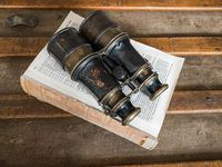 Vintage Binoculars on top of a deconstructed book makes for an interesting coffee table decor. Learn more decorating ideas at my weekly live sales on Facebook and shop my website.