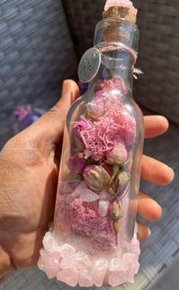 This jar is a Rose Quartz Crystal Energy jar . This jar has been decorated with crystals on the outards and it was created to generate love attraction and promote self love also good for stabilizing emotional energy  . Also dispels anxiety and negative feelings. It is filled with mosses of pink hues, Pink salt , rose buds and Pink Rose Quartz. This jar is great for new teenagers boosting self confidence <3 , divorcees or someone going up for a big change . It is one of my favorites <3 <3 We also