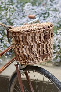 This woven wicker basket makes a charming and practical addition to your biking gear, perfect for packing your favorite beverages and snacks. Interior Velcro drink holder straps are designed to secure a variety of cups and bottles, while a removable lid and snap closure ensure easy access to what’s inside. Once you’ve reached your destination, carry your basket with you using the removable canvas shoulder strap. | Wicker Bicycle Basket at Terrain