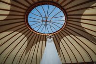 The Brides dres hanging photo inspirtation. Bridal Preparations wedding dress portrait. Yurt wedding, Tipi wedding. Camping at a wedding at Pencarrow Estate, country House Wedding venue in Bodmin, Cornwall, UK