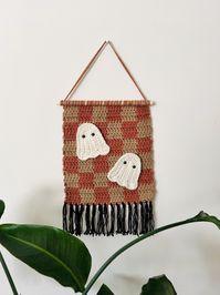 Cute spooky meets retro in this crocheted, checkered wall hanging sign! Perfect addition to your nursery, bedroom, living space to give things a retro feel and a festive touch! Crocheted on a 12" dowel and about 14" (from down to bottom of tassels). Yarn used is a blend of wool and acrylic.