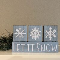 "Brighten your holidays this year with a set of our rustic, distressed, farmhouse Holiday Block Sets. Made from wood, these are stained in dark walnut, painted,  and sealed with vinyl  lettering. They are distressed to have that beautiful rustic farmhouse feel. Perfect for your entry way tables or mantels this Christmas season! * Let It Snow/Snowflake blocks measure 7\" long x 4\" tall at the highest stacked blocks. 1/2\" deep. All blocks are painted light blue. These blocks are all hand cut, st