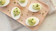 Classic deviled eggs get a seriously delicious upgrade with a fresh avocado filling in this easy recipe. Mash avocado with cooked egg yolks and stir in mayonnaise and lemon juice for a creamy texture and bright flavor. Spoon or pipe into cooked egg whites, garnish with chives and serve for any occasion that calls for a simple and tasty snack with a twist.