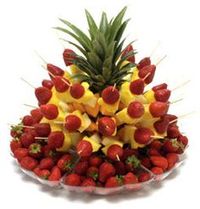 fruit kabob display in a pineapple. Cute.