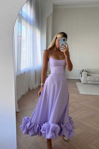 Flounce Bustier Midi Dress in Lavender. The corset with bones and cups flatters the body shape while the flounce in the bottom creates a dreamy and romantic feel. The dress fastens with a hidden zipper. Lined.