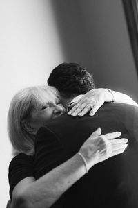 A, the groom, and his mom share a rae moment during his getting ready. Timeless wedding photography captured by Raphaelle Granger