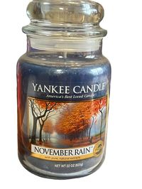 Enjoy the refreshing and unique fragrance of Yankee Candle's 22 oz Large Jar November Rain Scent. This rare and discontinued candle is perfect for creating a pleasant atmosphere in your kitchen, dining room, or living room. The blue jar and single wick make it an elegant addition to any home decor. Made of high-quality wax, this jar/container candle measures 7 inches in height and 4 inches in width. It features a wonderful November Rain scent that you will love. Choose this Yankee Candle for a relaxing and cozy ambiance. Candle hoarder needs a new furnace only reason I am selling.