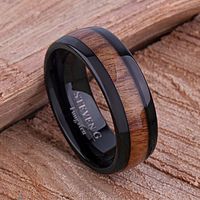 Tungsten Carbide Men's Wedding Band or Men's Engagement Ring 8mm Wide Black IP Plating Natural Rosewood Inlay This is one of more popular rings. Customers just love the way the Hawaiian Koa Wood center inlay stands out from the black IP sides of the ring. The wood's wide width shows well and makes this ring a rare find. Wear this ring day or night, at home or to a party, in the office or on the road - it's a real attention grabber. Order yours today! Outside Shape: Domed Inside Shape: Comfort Fi