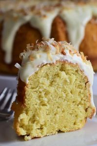 Double coconut cake made with shredded coconut and coconut milk is a delightful treat to serve with a cup of coffee.