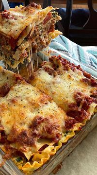 Layers of pasta, sausage studded tomato sauce, spinach and 3 Italian cheeses make this homemade lasagna recipe awesome.